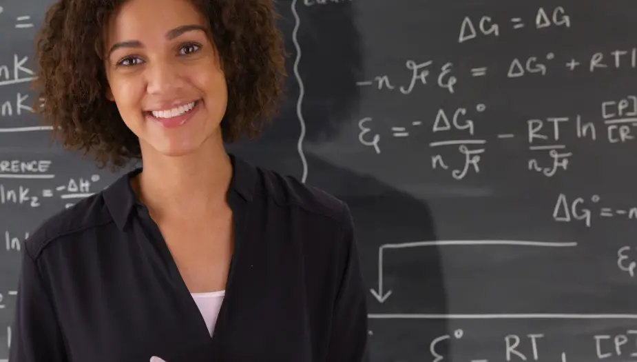 Lady with ENFJ personality standing by chalk board